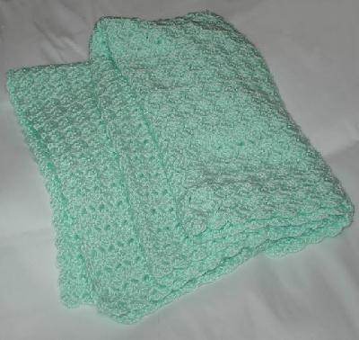 Crocheted baby afghan
This is a baby afghan I crocheted for a friend.  I couldn't get the entire thing in the photo, so I folded it until it fit.  Yes, it's huge.  I made it that way on purpose.

The stitch pattern is a random stitch pattern I grabbed from a book, probably 