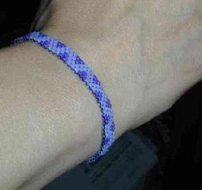 Purple peyote bracelet in three shades
This bracelet actually uses three shades of purple, but the light purples are iridescent and solid.  The iridescence doesn't show in the pic.

This was the first beaded item I ever made.
Keywords: beading