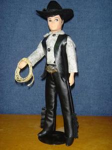 Save a Horse, Ride a Cowboy!
Gray cotton calico shirt with black faux-leather fringed vest and pants. Faux-snakeskin belt; store-bought (from Michael's) ten-gallon hat. Yee-haw!
