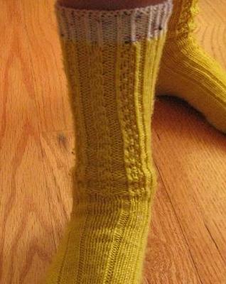 Yellow sock- Front view
<p>Can you make out the braided cable down the front of the sock?&nbsp; The ribs on either side of it are what I think the book called 