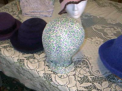 Those styrofoam thingys are useful but....
<p>They are NOT attractive.&nbsp; I spent some time yesterday cutting strips of old fabric and gluing them to the head form with white glue.&nbsp; So far so good.&nbsp; I intend to give it a couple of coats of spray polyeurethane and call it good.</p>
<p>I'm rather pleased with the improvement.</p>
