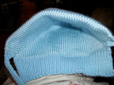 Inside
<p>The ribbing at the back is my own take.&nbsp; The original pattern is stockinette stitch which rolls up.&nbsp; The ribbing is to keep the back of baby's neck warm.&nbsp; Best part of this pattern is there's no seaming to be done.&nbsp; Hat comes off already together and the stitches are picked up on each side to make the ties.&nbsp; All that's left at the end is weaving in a few ends.</p>
