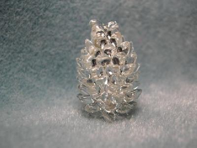 Silver Pinecone Delight on Lighter Background
<p>Here is the silver pinecone on a lighter background. Unfortunately, the upper beads look darker because they were reflecting the lamp color.</p>
Keywords: pinecone silver long magatama lighter background