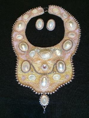 Pink Beauty
<p>This set was also a finalist in the 2009 Fire Mountain Gems Seed Bead contest. This is a bib collar with mother of pearl cabochons, fresh water pearls, Swarovski crystals and 6 different shades of seed beads. It has a double hook-n-eye clasp in silver.</p>

