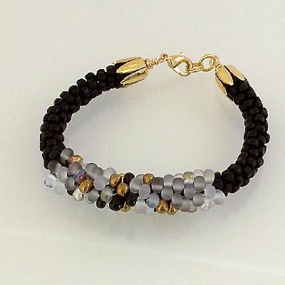 Black and Bronze Kumihimo Bracelet
<p>This bracelet is made with black seed beads on both ends with a mix of translucent white, bronze, and black drops in the center.</p>
Keywords: kumihimo drops bracelet